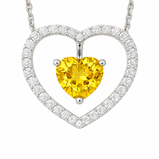 Yellow sapphire necklace with a 6 mm heart cut and moissanite halo, crafted in white gold-plated 925 silver. Elegant and radiant. Available now at BSI Jewelry.