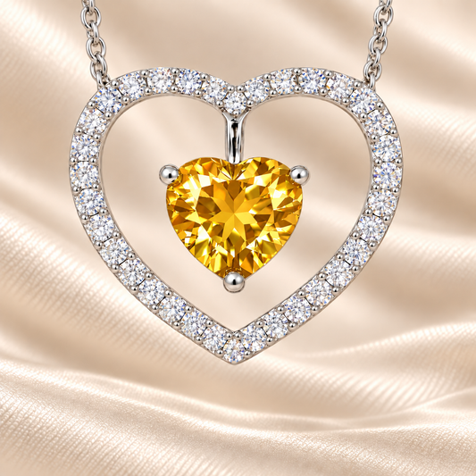 Yellow sapphire necklace with a 6 mm heart cut and moissanite halo, crafted in white gold-plated 925 silver. Elegant and radiant. Available now at BSI Jewelry.