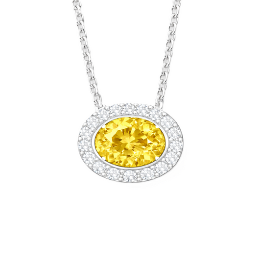 Yellow sapphire pendant with a 7×5 mm oval stone in white gold-plated 925 silver, accented with moissanite. Warm and elegant. Available now at BSI Jewelry.