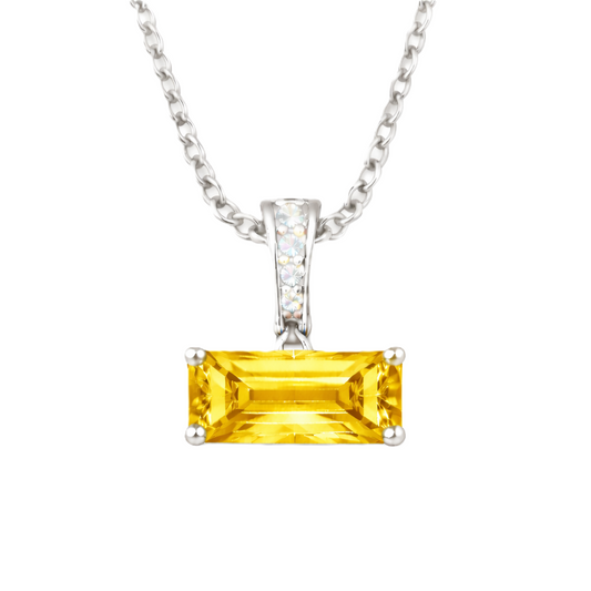 Yellow sapphire pendant with an 8×5 mm baguette in white gold-plated 925 silver, accented with moissanite. Elegant and refined. Available now at BSI Jewelry.
