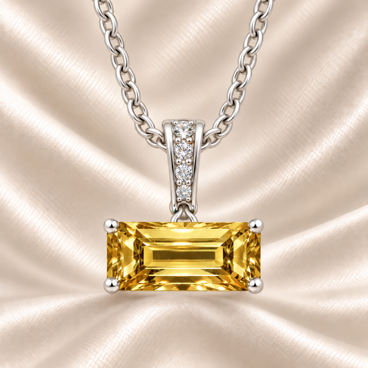 Yellow sapphire pendant with an 8×5 mm baguette in white gold-plated 925 silver, accented with moissanite. Elegant and refined. Available now at BSI Jewelry.