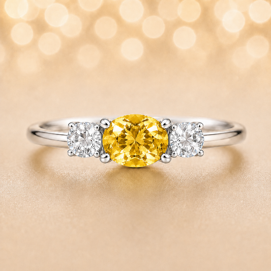 Yellow sapphire ring, 5×4 mm oval with moissanite accents in white gold-plated 925 silver. Bright, elegant, and hypoallergenic. Available now at BSI Jewelry.