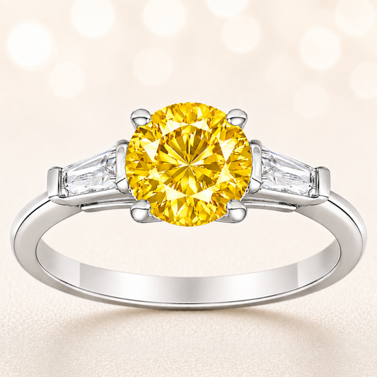 Yellow sapphire ring, 6 mm round, with tapered moissanite accents in white gold-plated 925 silver. Bright and elegant. Available now at BSI Jewelry.