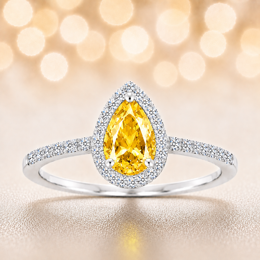 Yellow sapphire ring with a 7×5 mm pear cut, with moissanite in white gold-plated 925 silver. Elegant and timeless for daily wear. Available now at BSI Jewelry.
