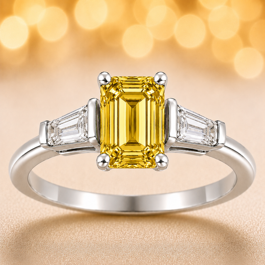 Yellow sapphire ring, 7×5 mm emerald cut with tapered moissanite, crafted in white gold-plated 925 silver. Elegant and radiant. Available now at BSI Jewelry.