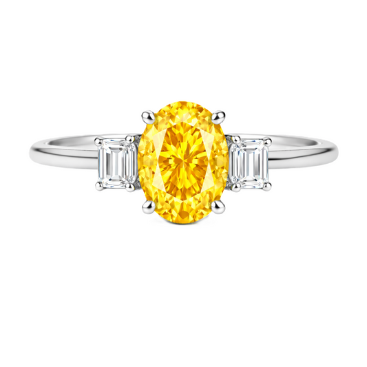 Yellow sapphire ring with 7×5 mm oval center and 5×3 mm moissanite sides in white gold-plated 925 silver. Elegant and refined. Available now at BSI Jewelry.