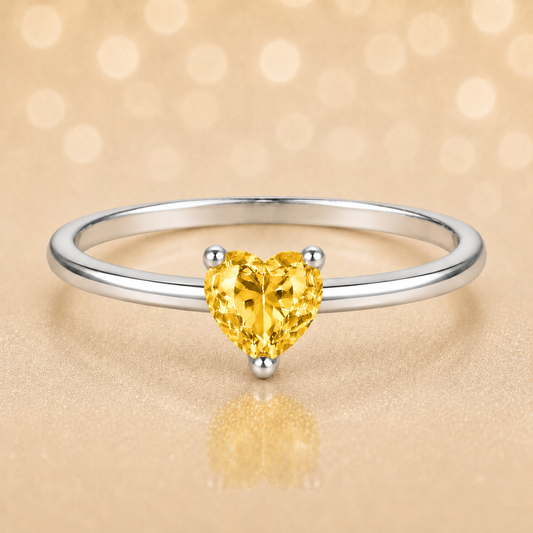 Yellow sapphire solitaire ring with a 5 mm heart in white gold-plated 925 silver. Elegant, minimal, and timeless for daily wear. Available now at BSI Jewelry.