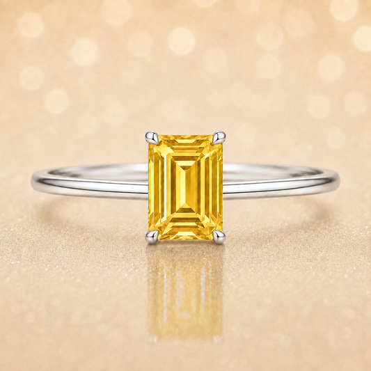 Elegant 6×4 mm emerald-cut yellow sapphire ring crafted in white gold-plated 925 silver with palladium alloy. Timeless brilliance. Available now at BSI Jewelry.