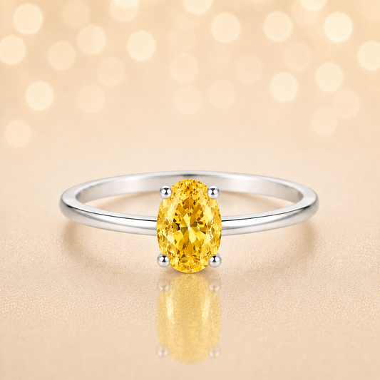Yellow sapphire solitaire ring with a 6×4 mm oval in white gold-plated 925 silver. Elegant, minimal, and timeless for daily wear. Available now at BSI Jewelry.