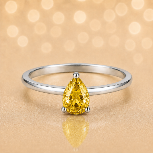 Yellow sapphire solitaire ring with a 6×4 mm pear in white gold-plated 925 silver. Elegant, minimal, and timeless for daily wear. Available now at BSI Jewelry.