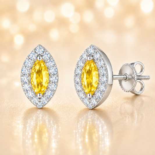 Yellow sapphire stud earrings with 5×2.5 mm marquise in white gold-plated 925 silver, accented with moissanite. Warm and elegant. Available now at BSI Jewelry.
